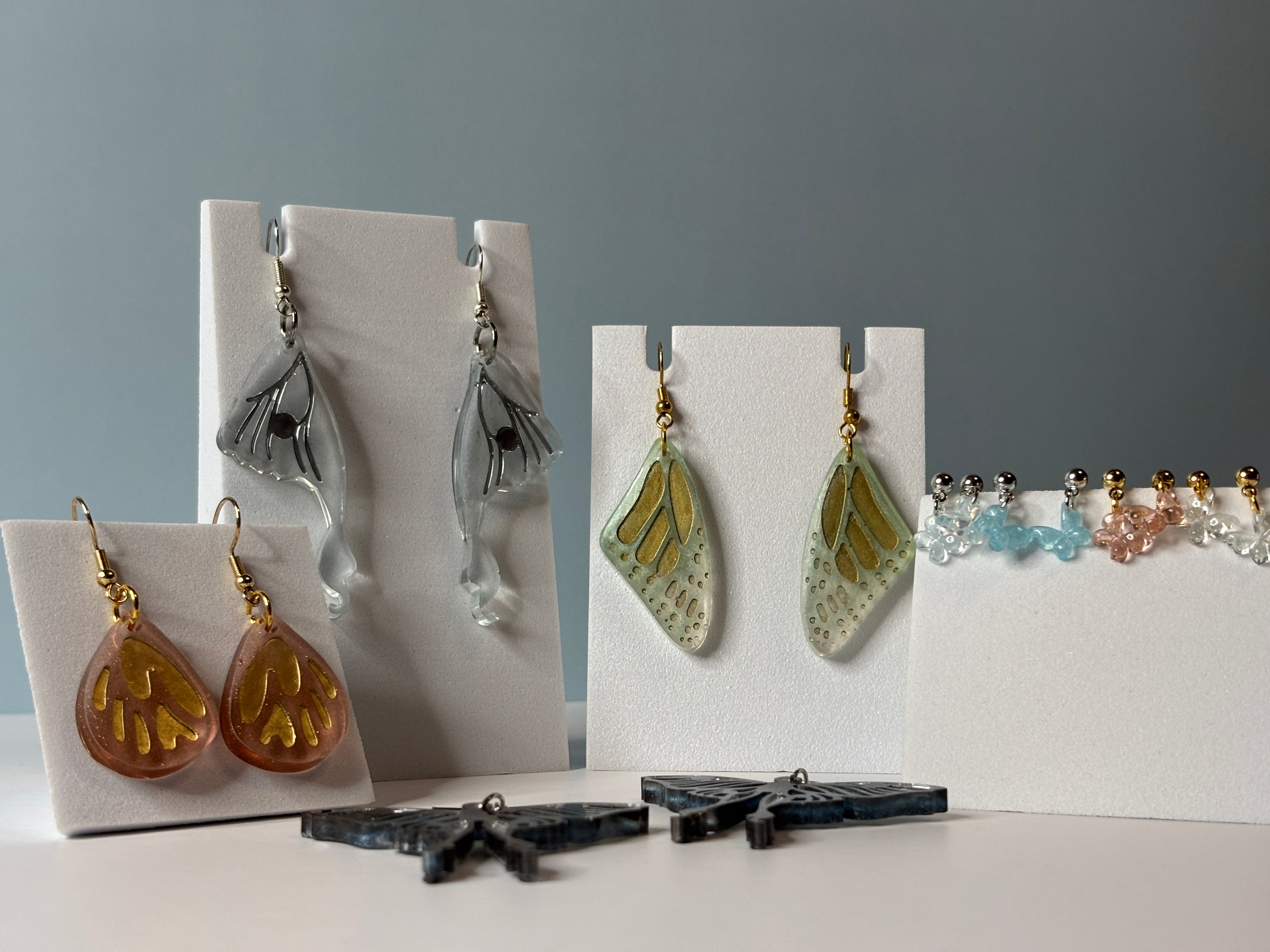 Set of earrings displayed on a blue background