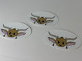 Three oval-shaped stickers with cartoonish animal face designs on a white background.