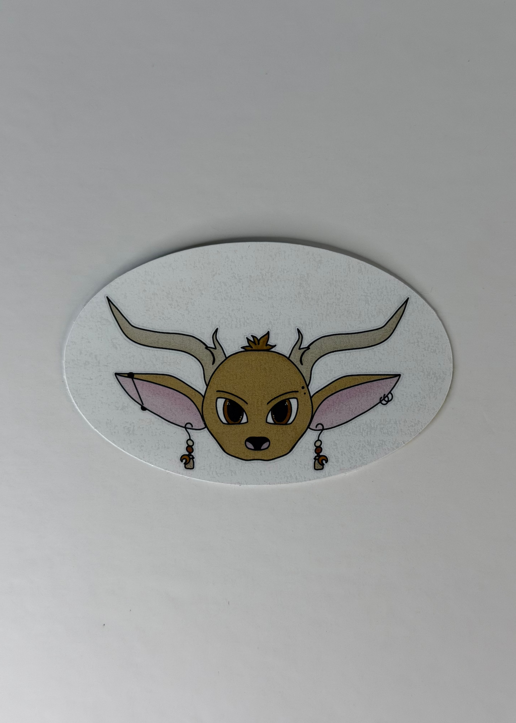 Sticker of a deer face with large ears and antlers on a white background