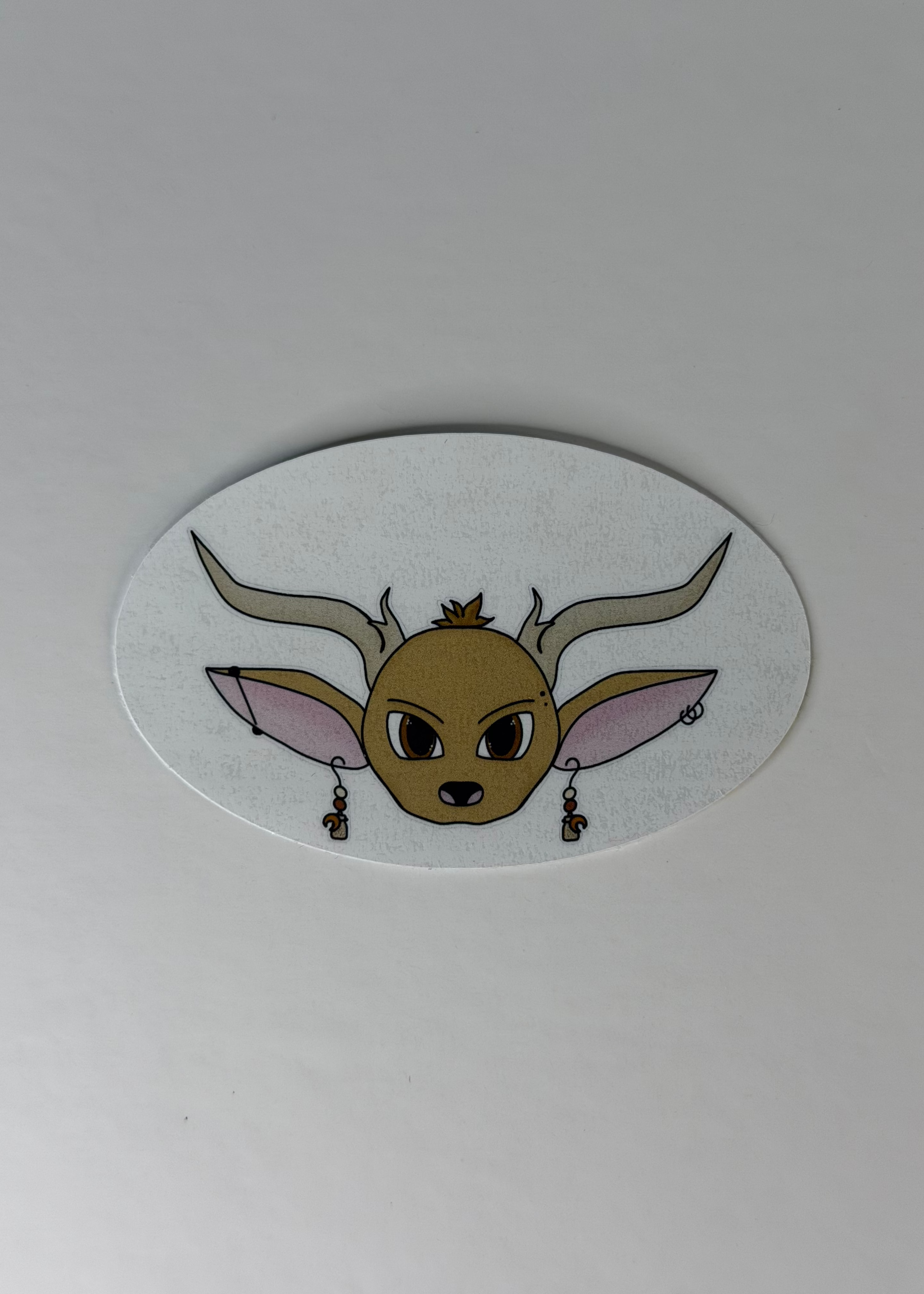 Sticker of a deer face with large ears and antlers on a white background